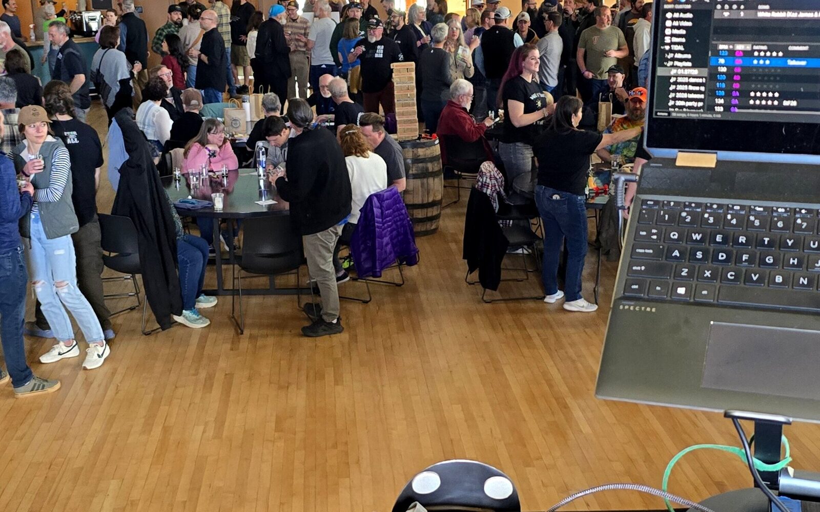DJ Lil Spoon performing at a live event with crowd in background